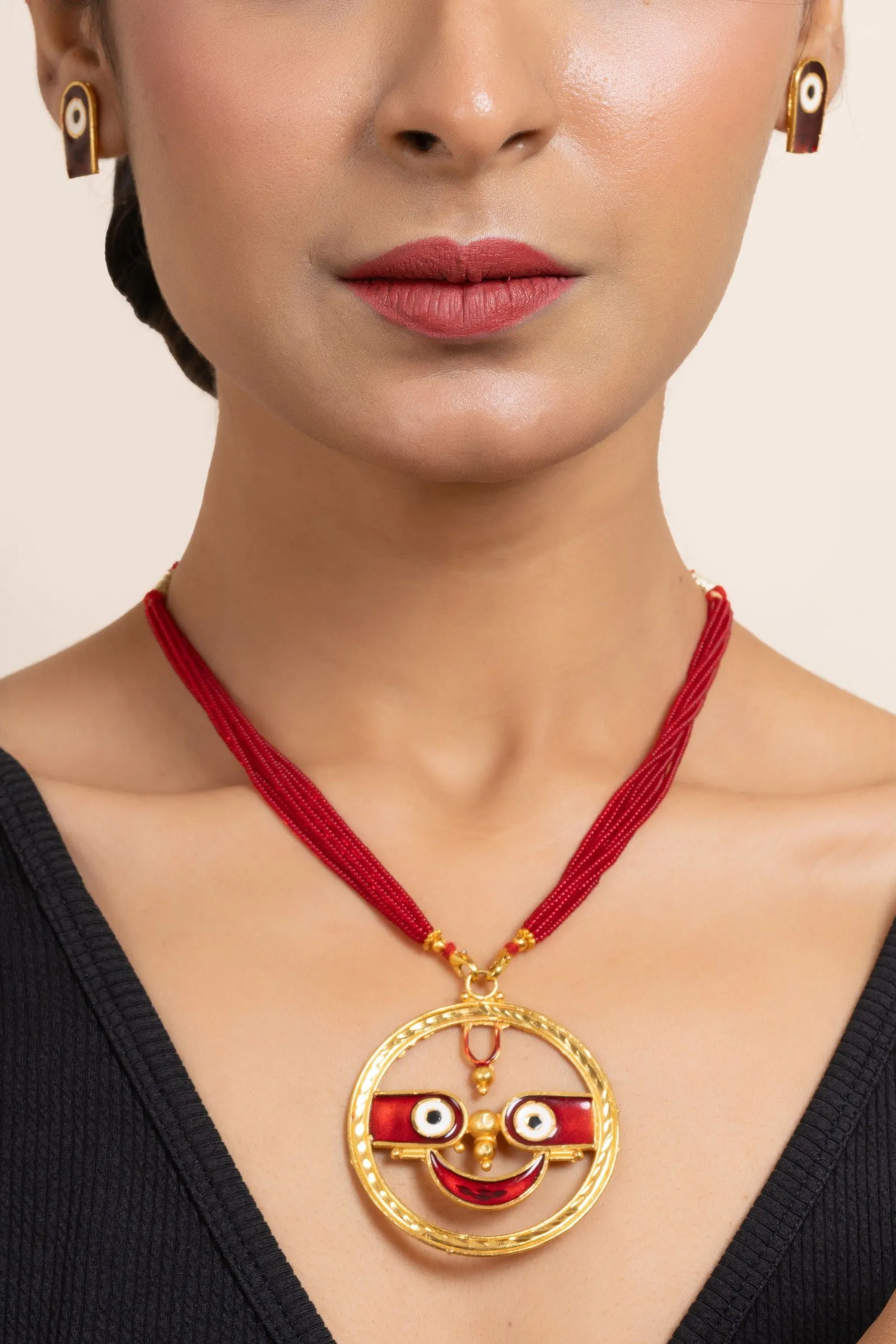 Gold Plated Meenakari Round Jagannath Pendant Necklace with Matching Earrings & Red Tussle Jewelry Set